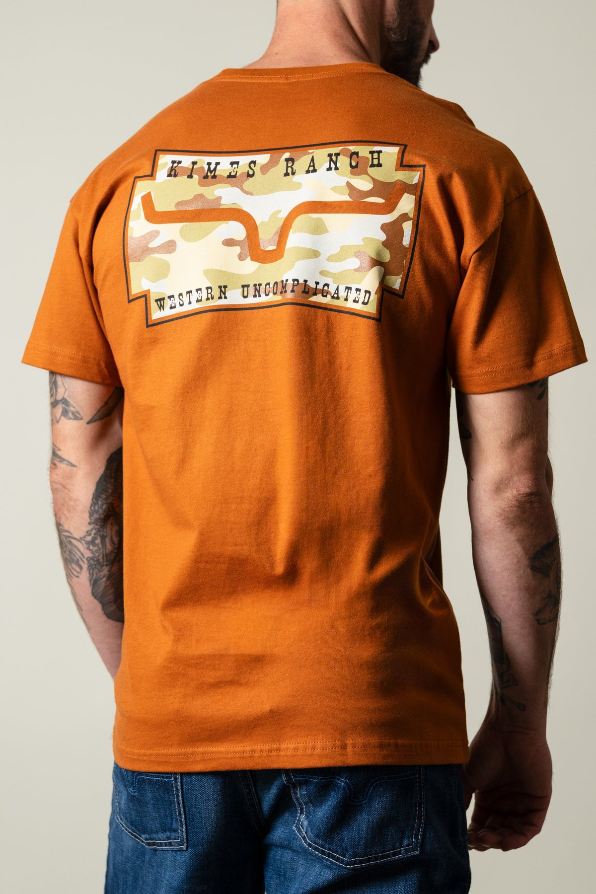 Kimes Ranch Clay Camo Crest men's T-shirt back view with Kimes Ranch and Western Uncomplicated graphic print