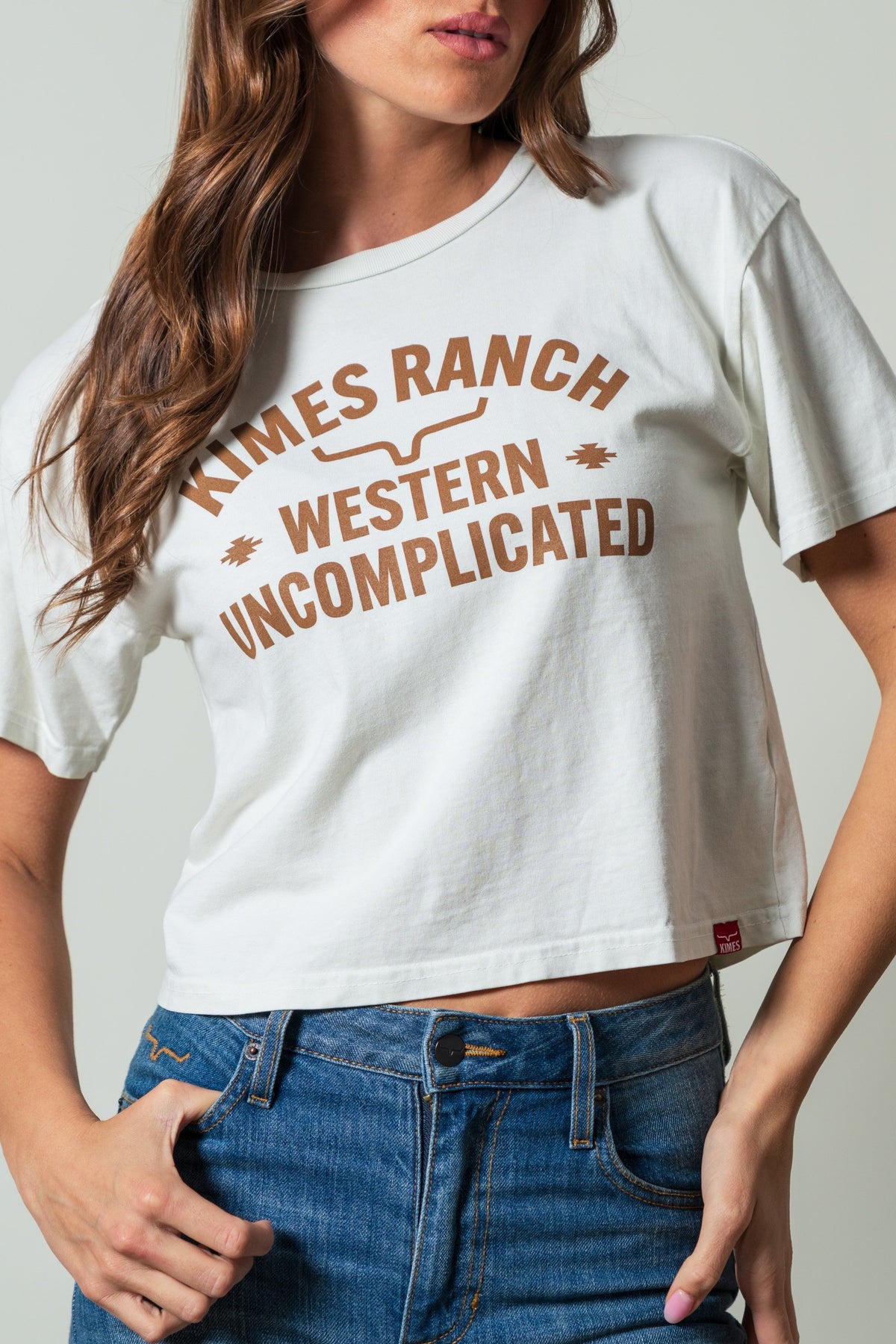 Kimes Ranch Cavell Natural crewneck shirt featuring arched 'KIMES RANCH' and stacked 'WESTERN UNCOMPLICATED' graphics