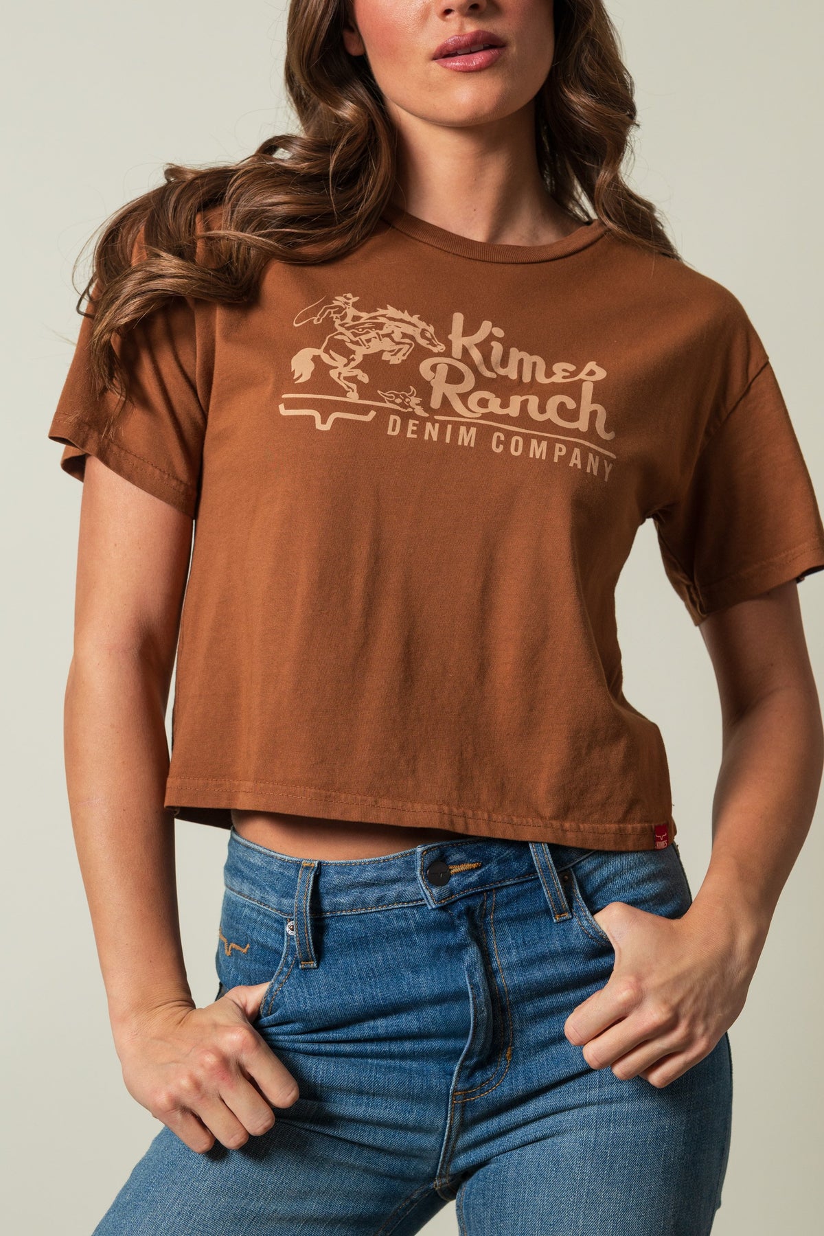 Kimes Ranch Davona Dale women's short sleeve crewneck tee in brown, printed with a Kimes Ranch logo graphic