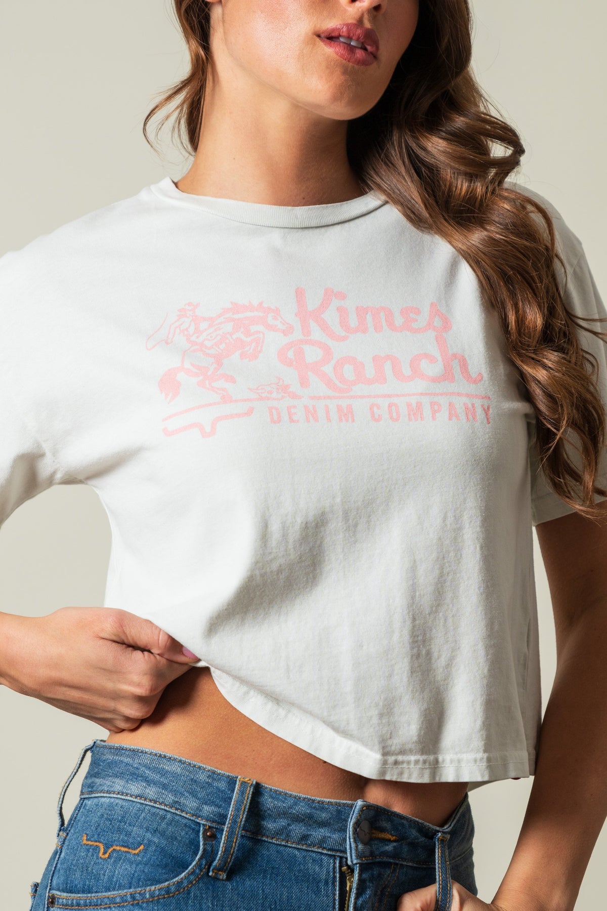 Kimes Ranch Davona Dale t-shirt in natural with pink graphic logo of horse rider, Kimes Ranch DENIM COMPANY