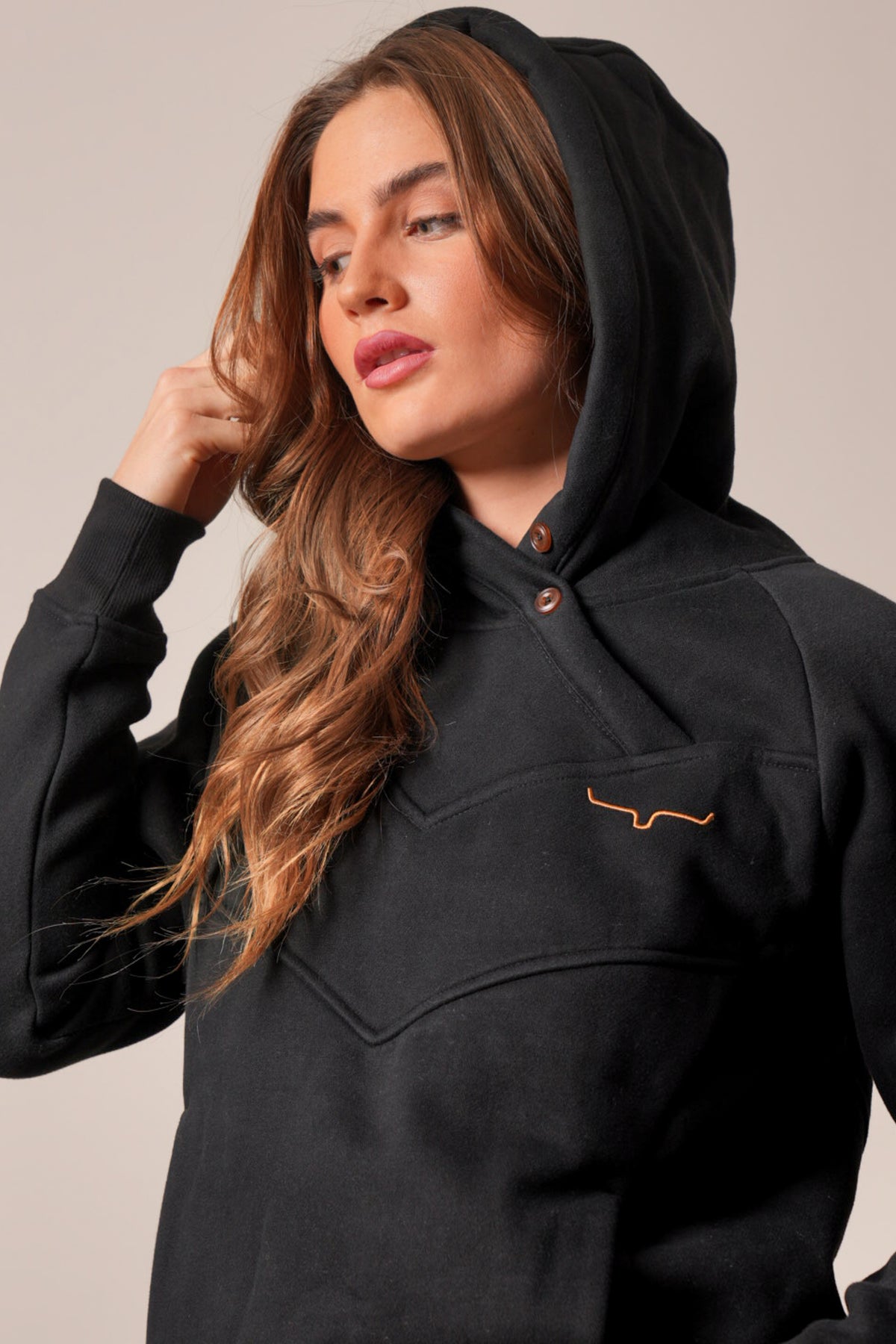 Kimes Ranch Ella black hoodie featuring a two-snap placket, long sleeves, and embroidered Kimes Ranch logo on the chest