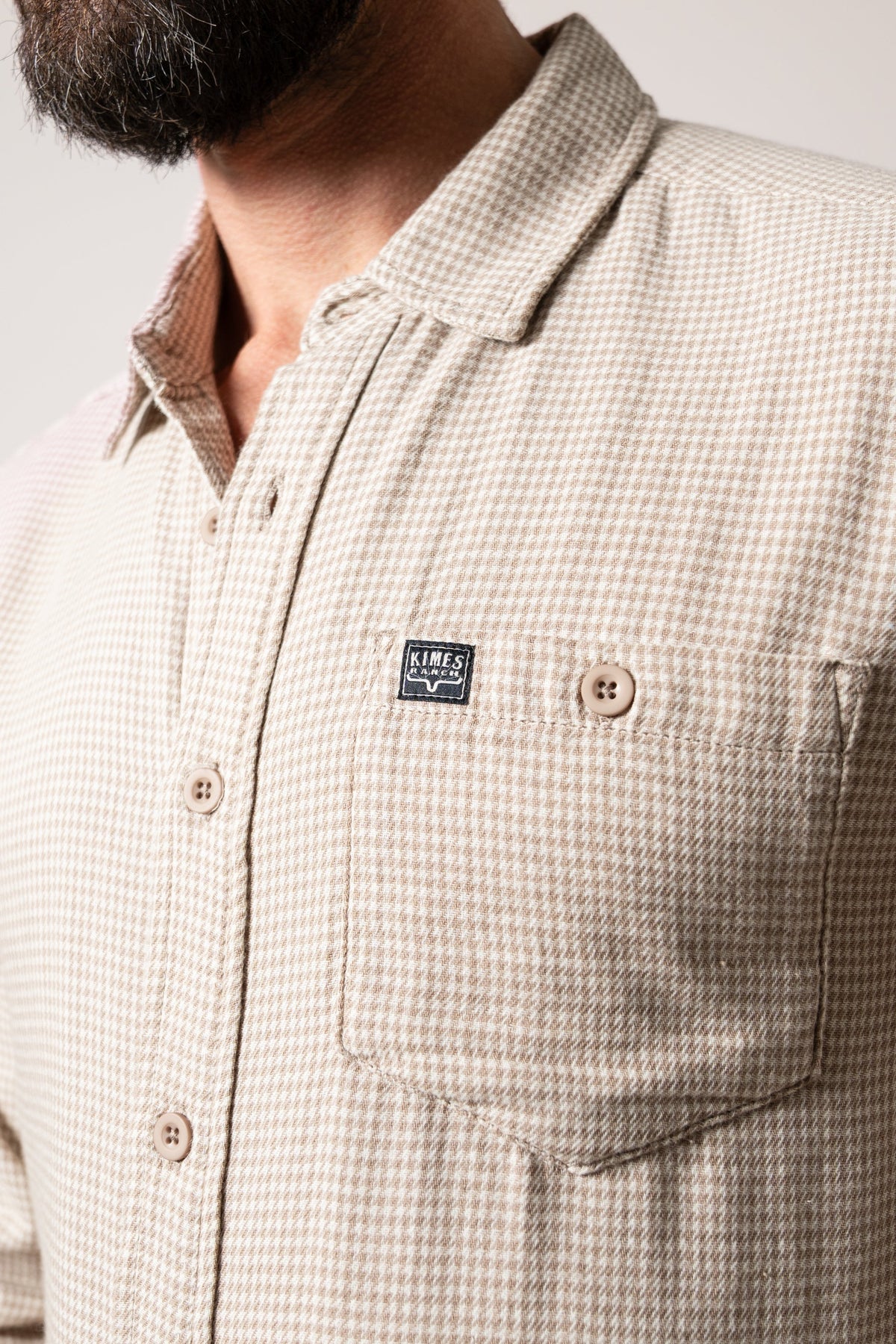 Kimes Ranch Kelso Natural Dress Shirt, featuring a collar, chest pocket with Kimes Ranch logo, and button closure