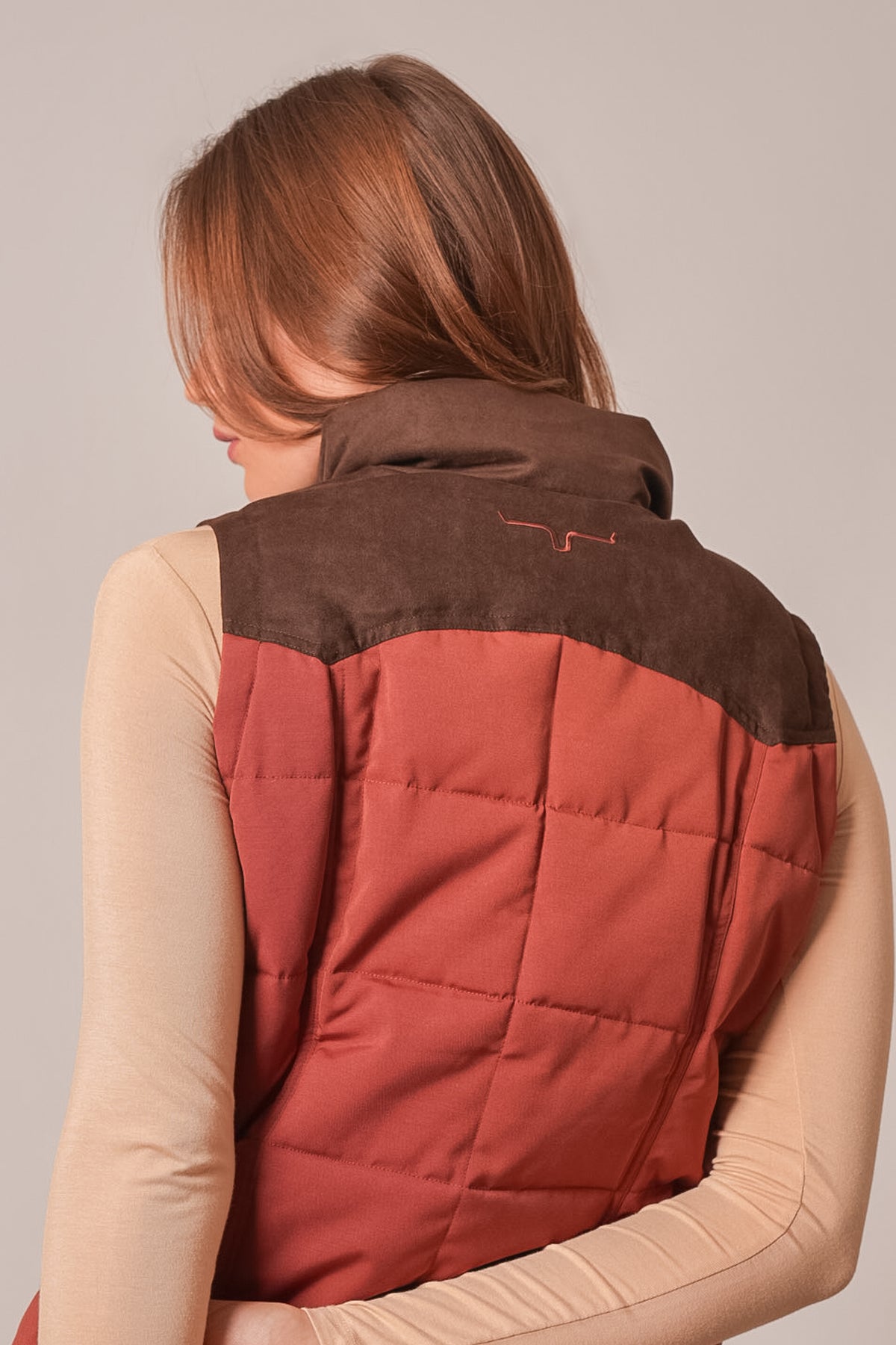 Kimes Ranch Lenora vest in burnt red showing back view with quilted paneling and brown suede yoke
