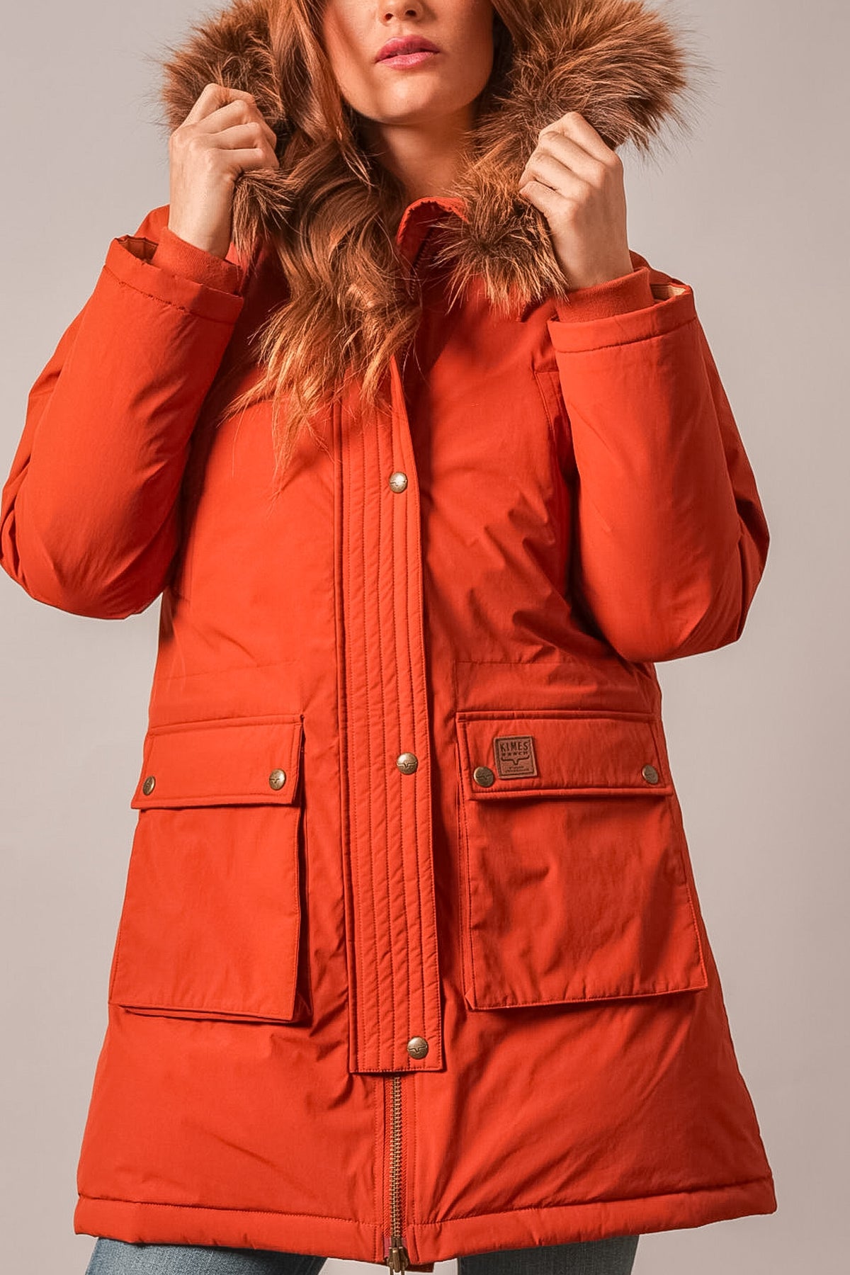 Kimes Ranch Montana jacket in Burnt Red with faux fur trim hood, two flap pockets, and Kimes Ranch logo