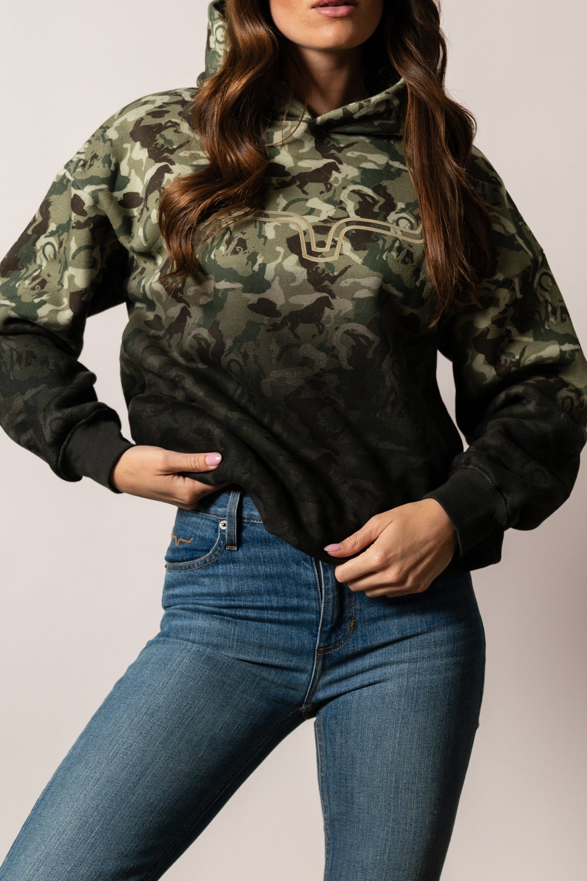 Kimes Ranch Sloane hoodie in green camo with horse silhouettes, long sleeves, kangaroo pocket, and front logo