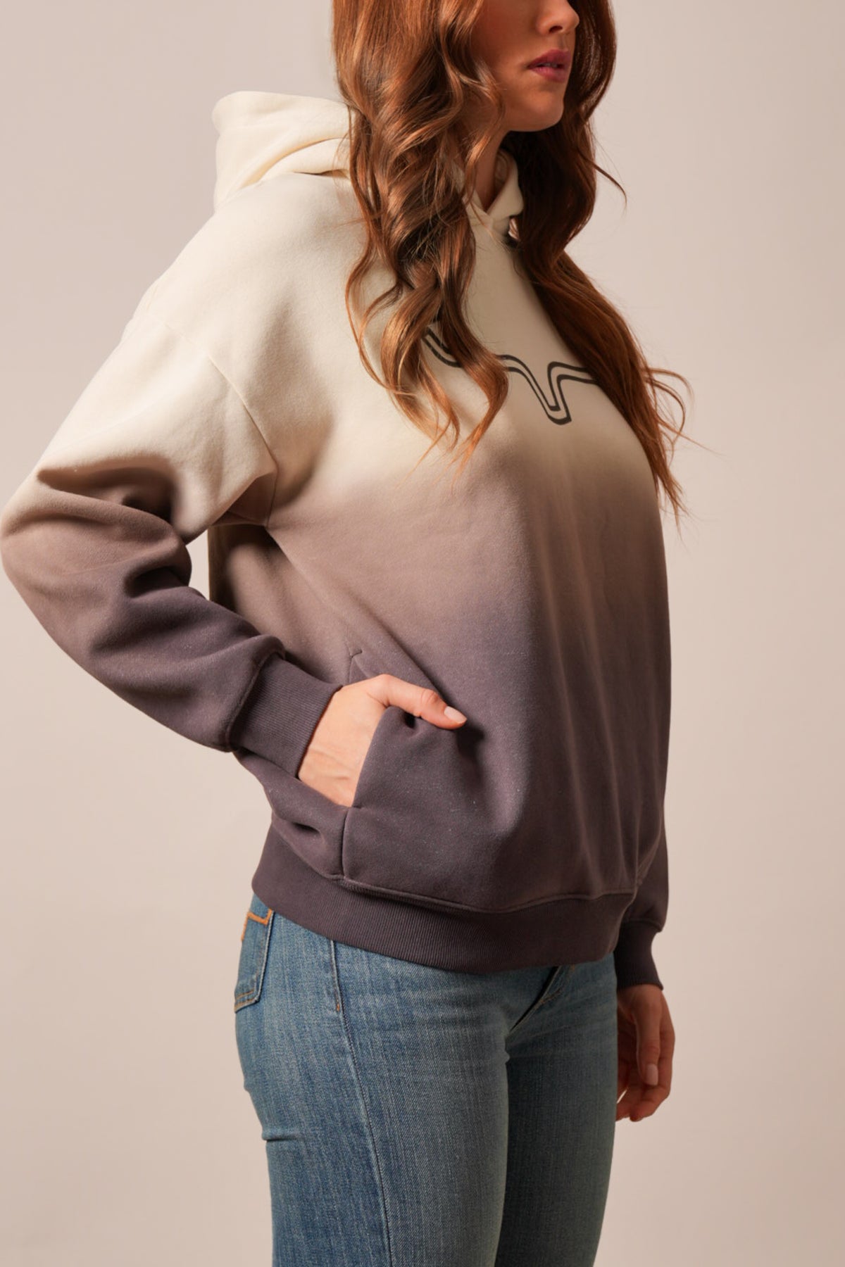 Kimes Ranch Sloane hoodie in a natural color with a front pocket and a stylized steer logo on the chest