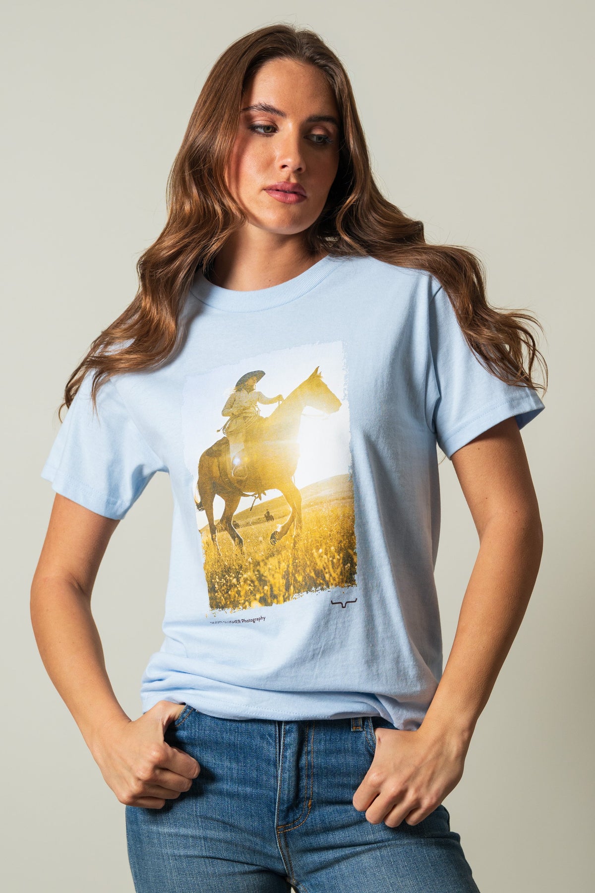 Kimes Ranch SS Riding Sunshine powder blue short sleeve shirt with a graphic print of a rider on a horse in a sunny field