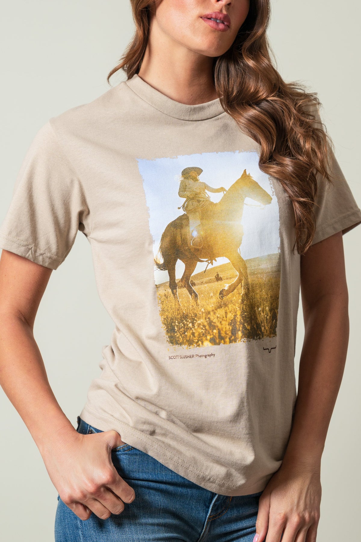 Kimes Ranch SS Riding Sunshine shirt in Sand with a rider on a horse, Scott Slusher Photography text, Kimes Ranch logo