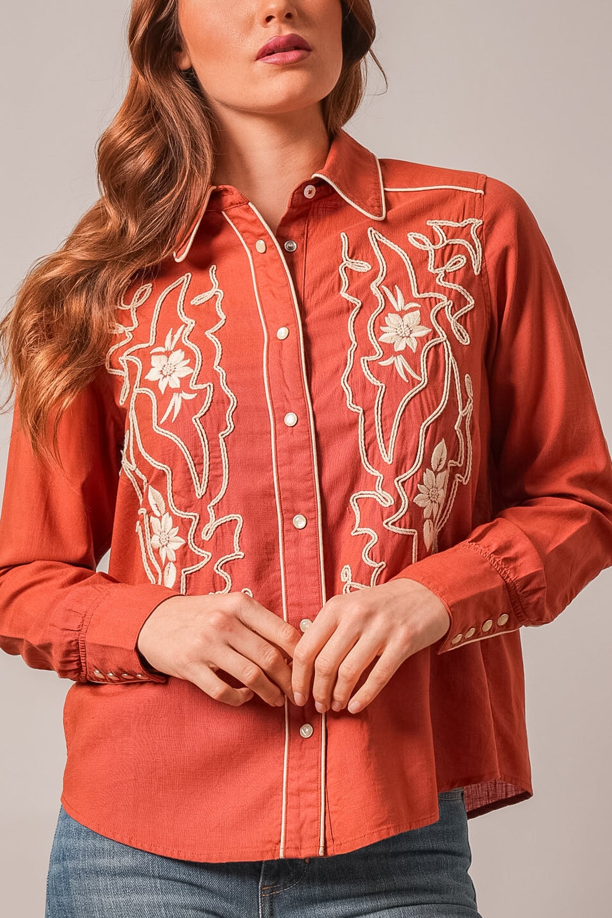 Kimes Ranch Stevie long sleeve button-up in burnt red with cream floral embroidery and contrasting stitching on front yokes