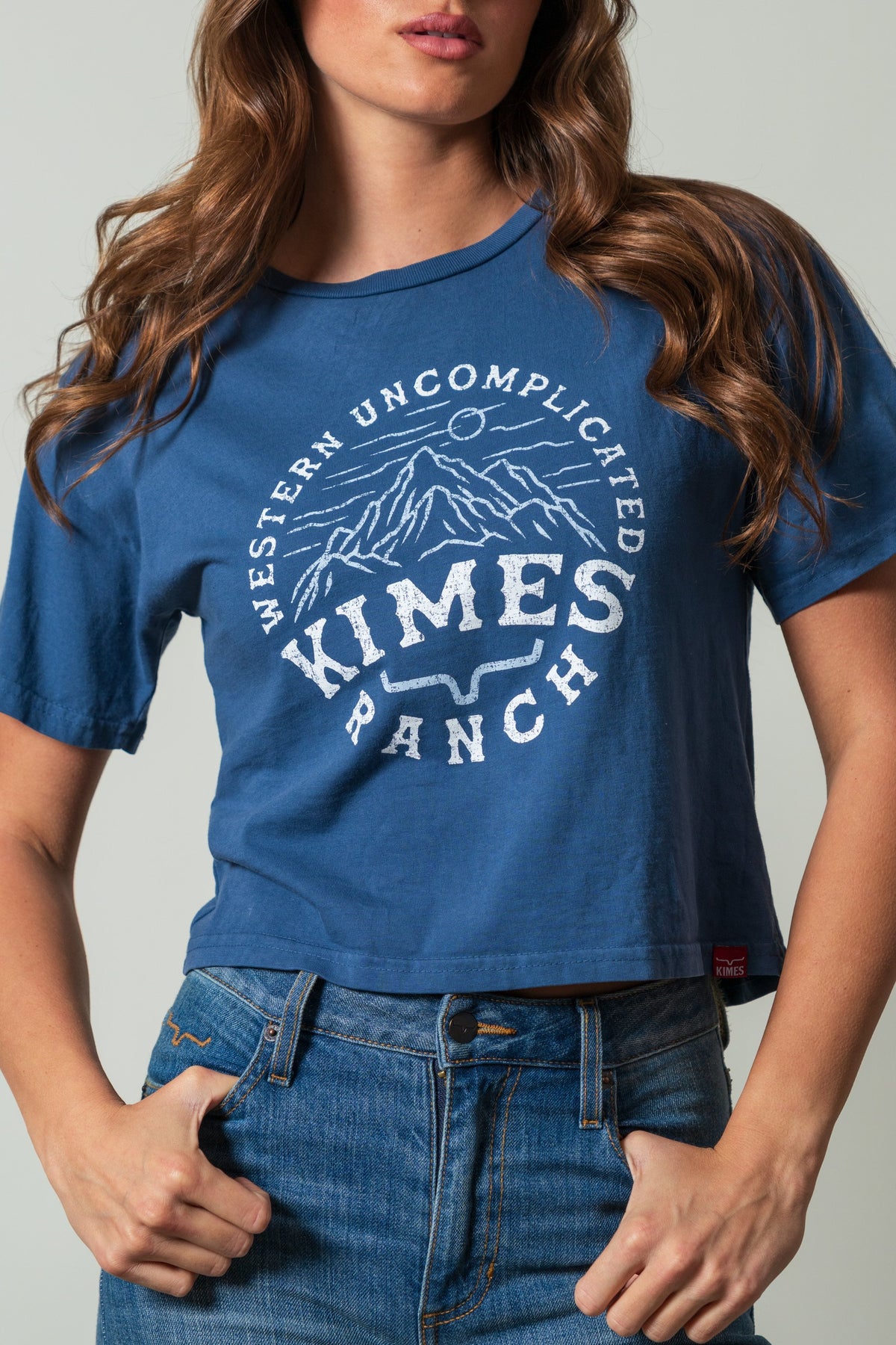 Kimes Ranch The Pass shirt in dark blue with a white mountain graphic and "Western Uncomplicated Kimes Ranch" text
