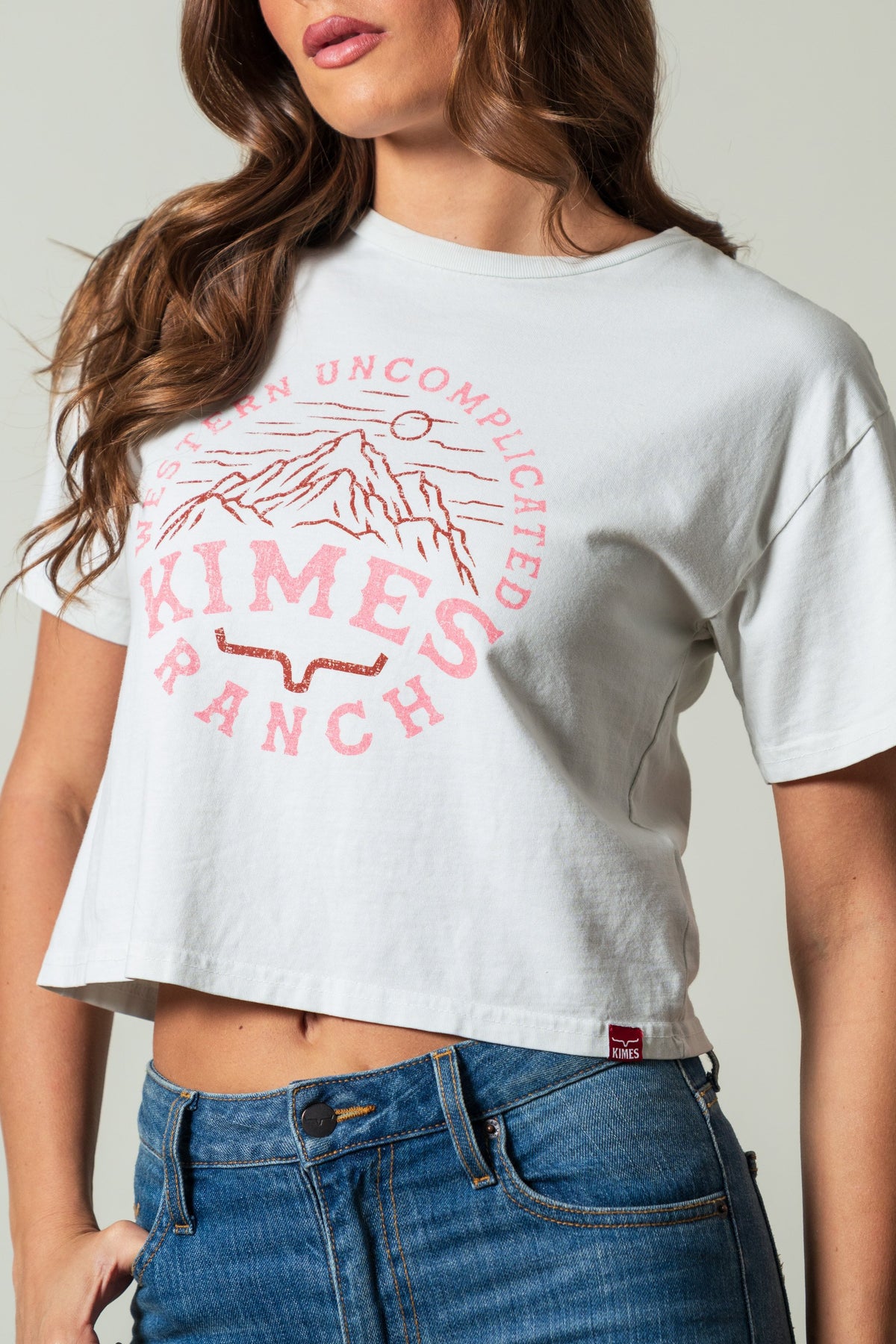 Kimes Ranch The Pass crop tee in natural with a pink graphic of mountains, Western Uncomplicated Kimes Ranch