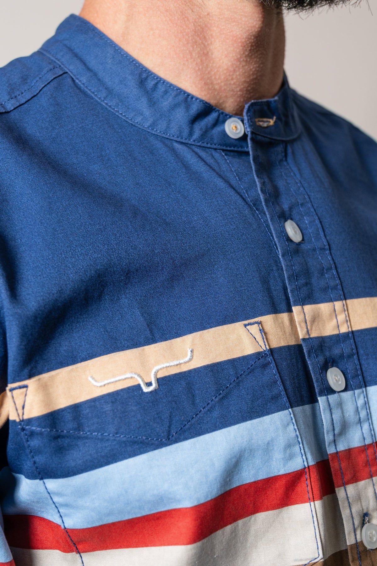 Kimes Ranch ZT Caliber dress shirt in Dark Blue with horizontal tan, red, and light blue stripes