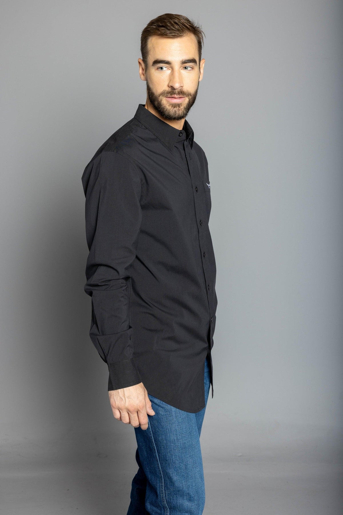 Kimes Ranch KR Team Dress Shirt (Long) in Black, side view, with long sleeves and a chest logo