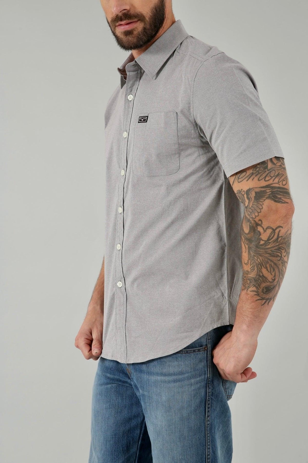 Kimes Ranch Linville Short Sleeve Dress Shirt in Grey Heather, side view, with a chest pocket and logo