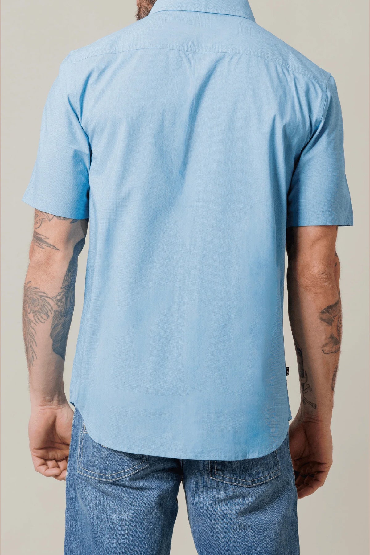 Kimes Ranch Linville Short Sleeve Dress Shirt in Mid Blue, back view, with a back yoke and short sleeves