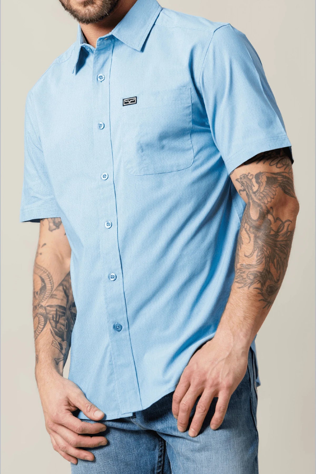 Kimes Ranch Linville Short Sleeve Dress Shirt in Mid Blue with a chest pocket and logo patch