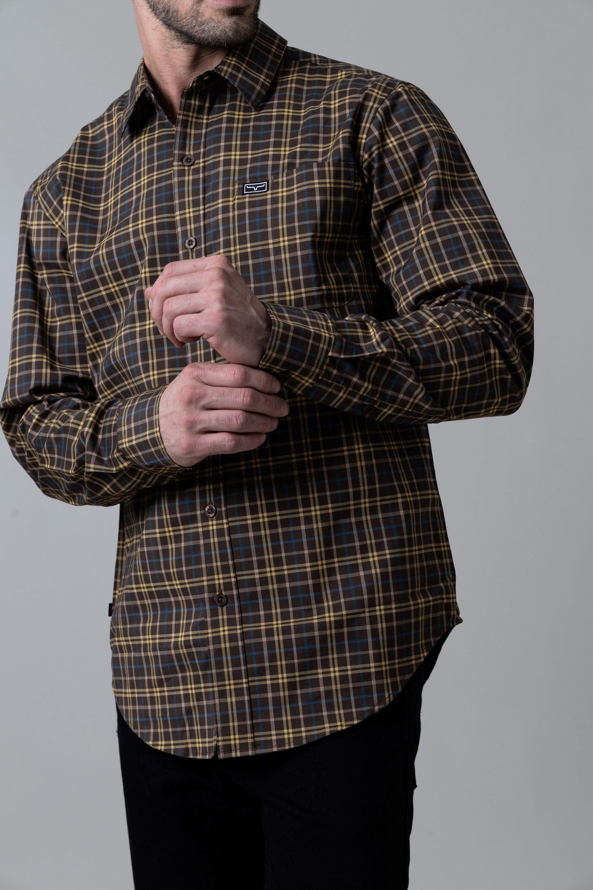 Kimes Ranch Lucas dress shirt in Navy with a brown and yellow plaid pattern and a chest pocket with the Kimes Ranch logo