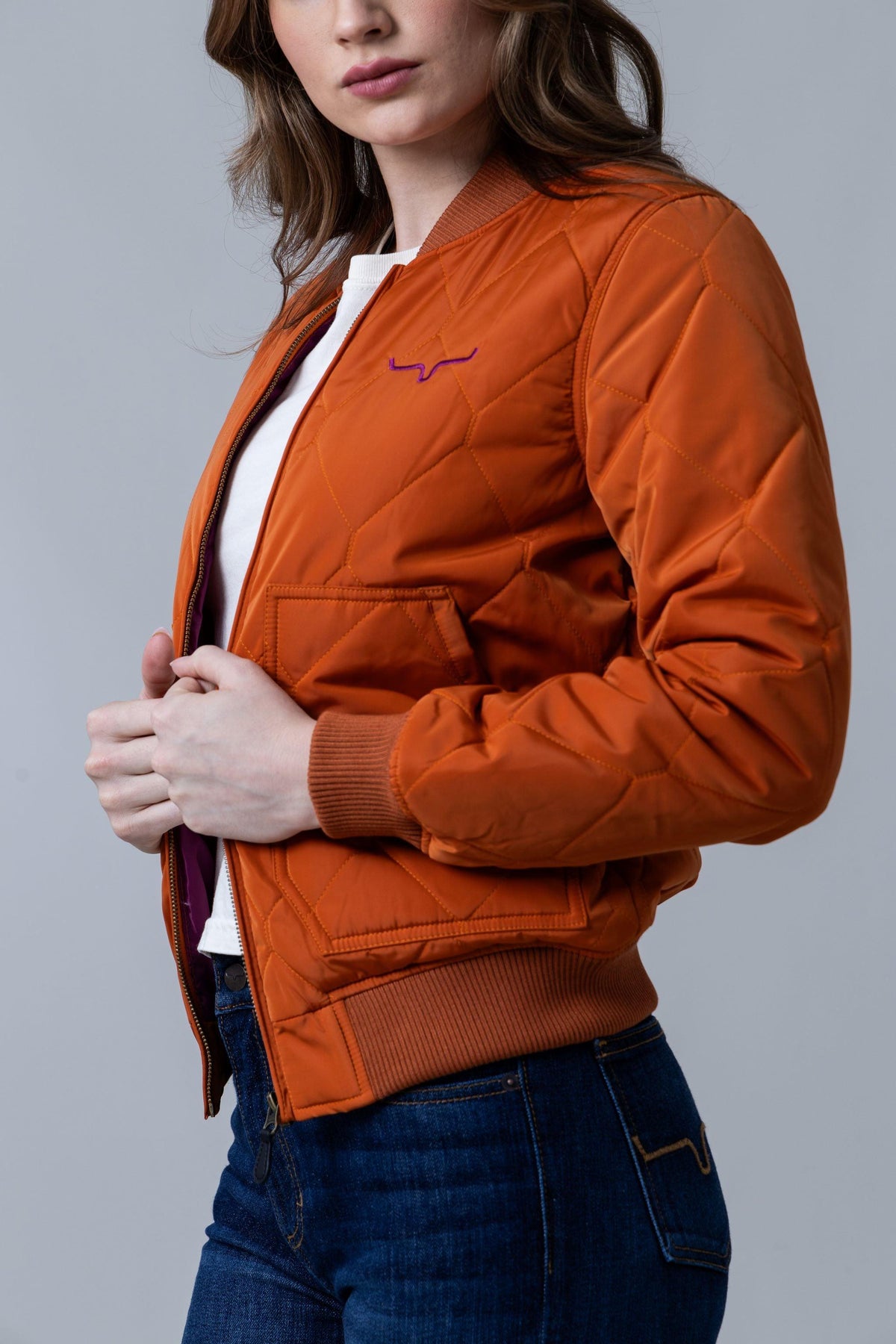Kimes Ranch Marino Bomber Jacket in Burnt Orange, side view, with diamond quilting and ribbed trim