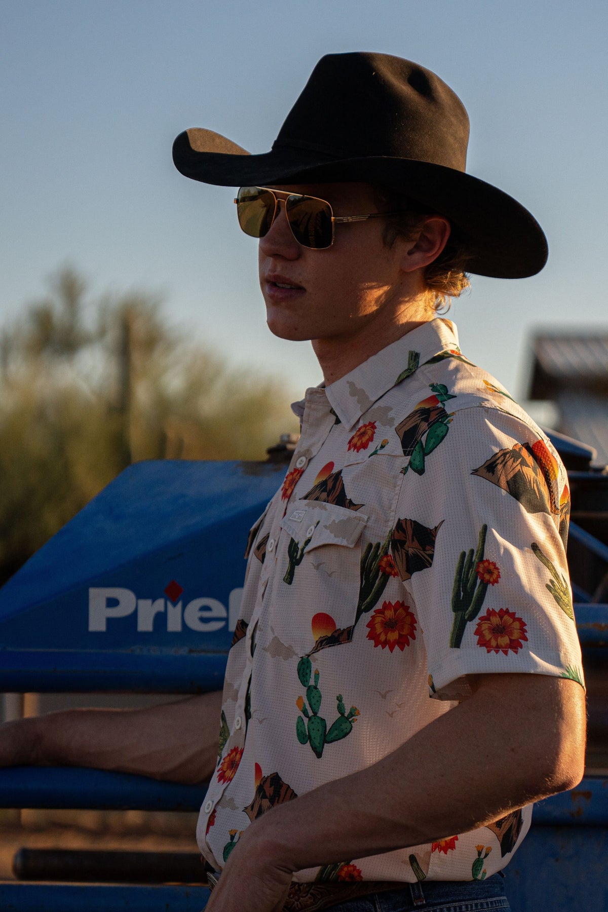 Kimes Ranch Berry dress shirt in Natural, side view, with a cactus and mountain print and a chest pocket