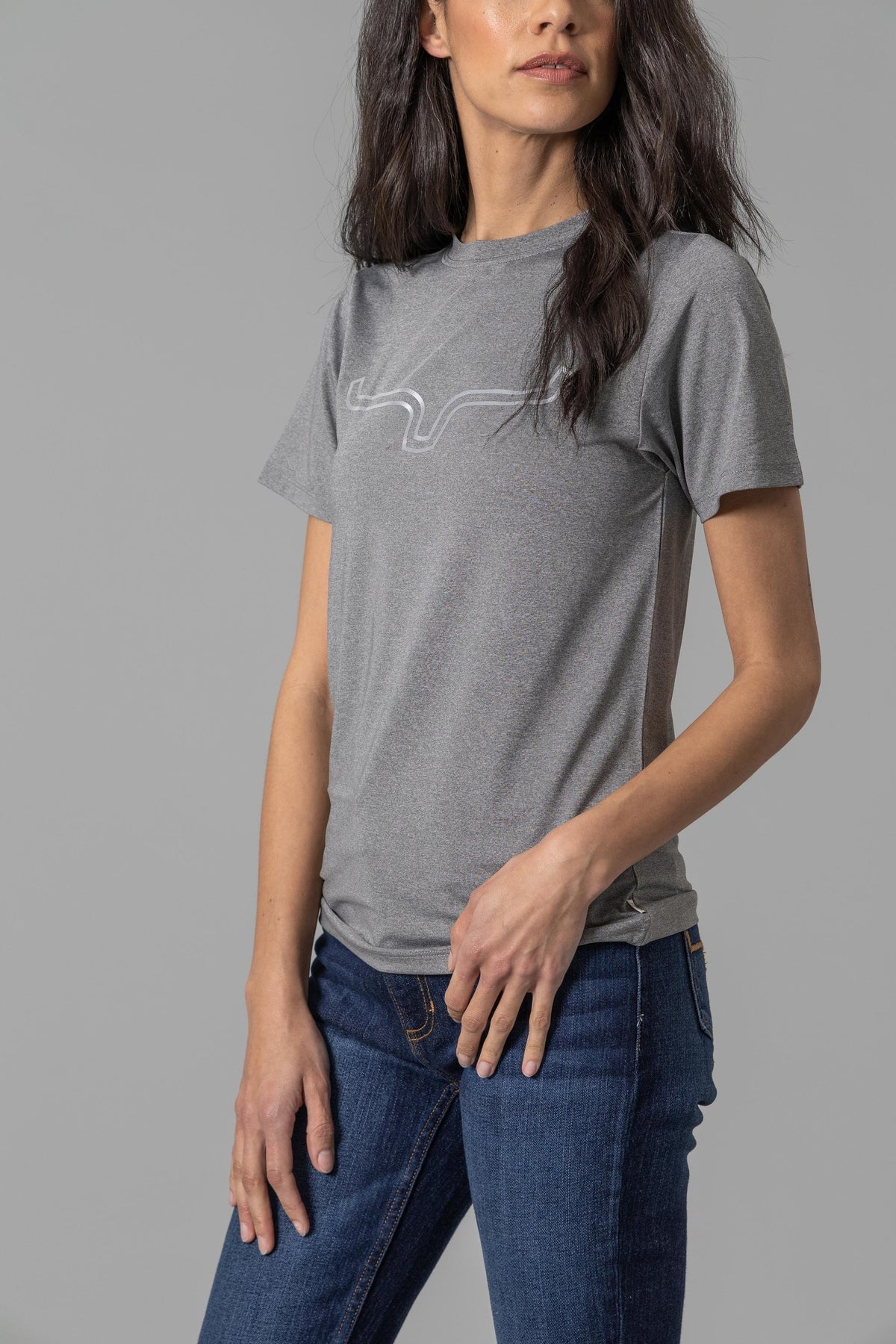 Kimes Ranch Ladies Outlier Tech Tee Shirt in Charcoal Heather with a reflective outline graphic on the chest