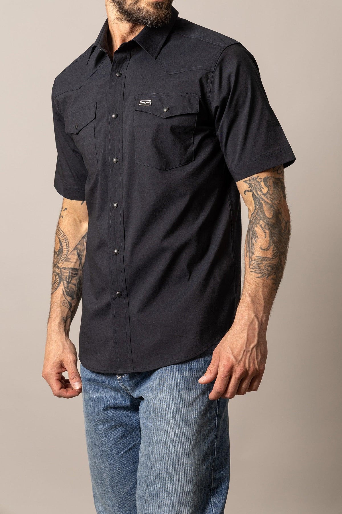Kimes Ranch Rio Short Sleeve Dress Shirt in Black, side view, with button front and two chest pockets
