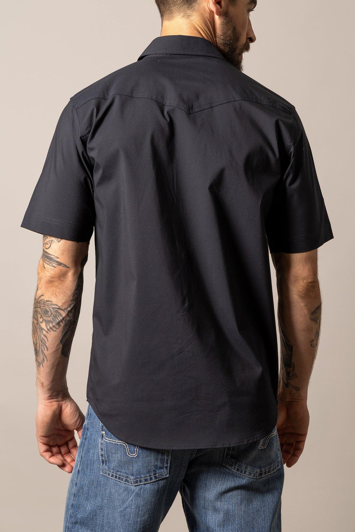 Kimes Ranch Rio Short Sleeve Dress Shirt in Black, back view, with a back yoke and short sleeves