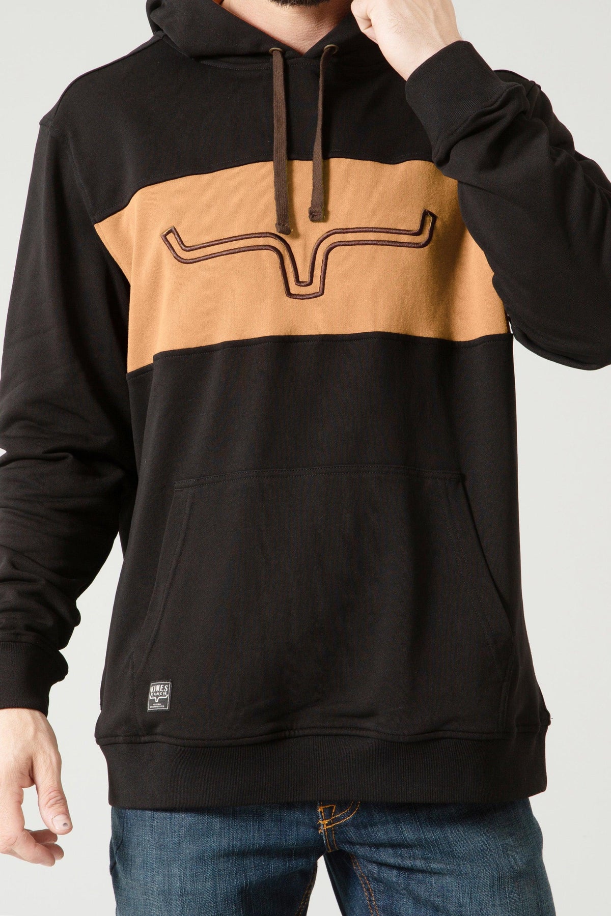 Kimes Ranch Ripon Hoodie in Black with a tan chest panel and the Kimes Ranch logo with a kangaroo pocket