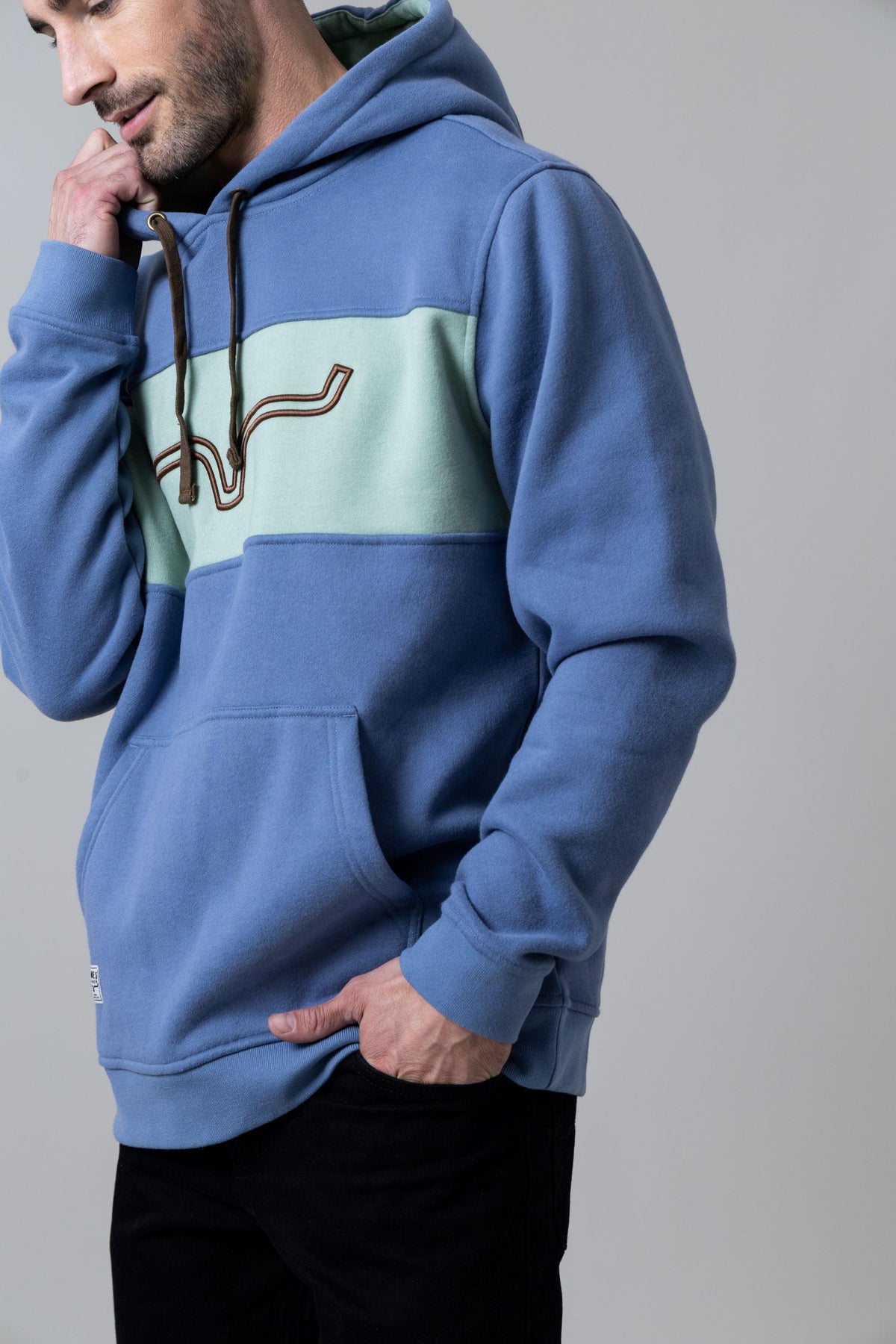 Kimes Ranch Ripon Hoodie in Slate Blue, side view, with a mint green chest panel and embroidered logo