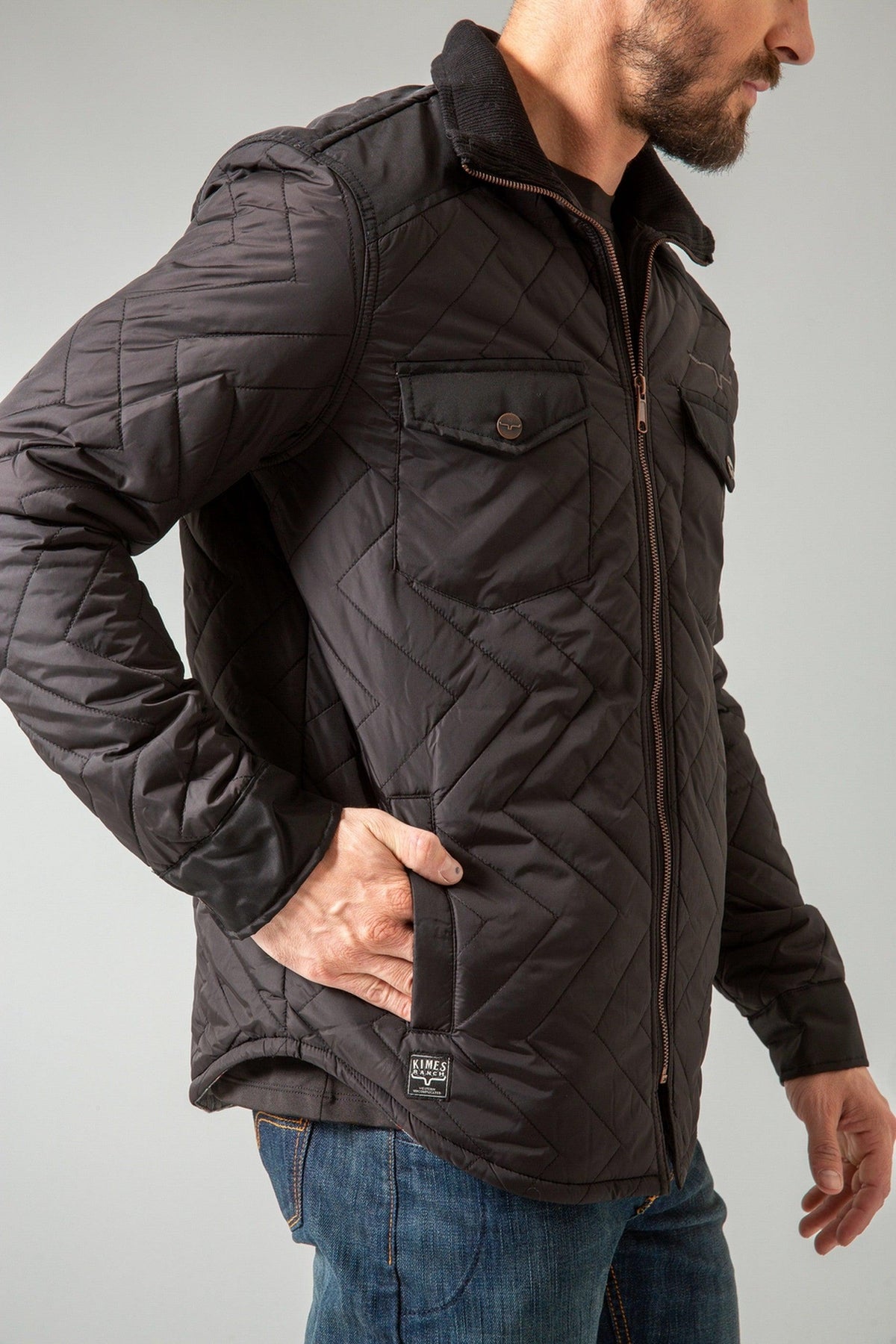 Kimes Ranch Skink Jacket in Black, side view, with a chevron quilted pattern and zip front