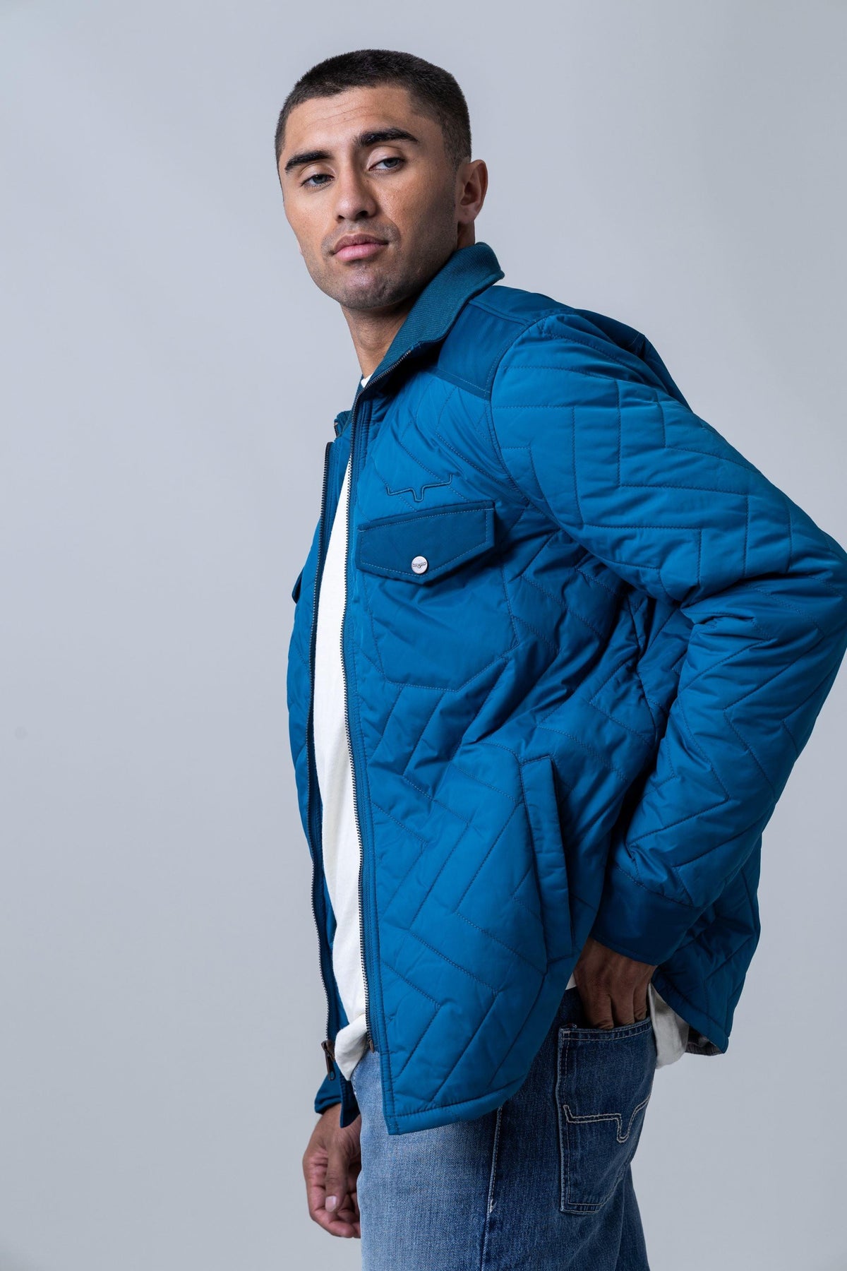 Kimes Ranch Skink Jacket in Mid Blue, side view, with a quilted diamond pattern and a chest pocket