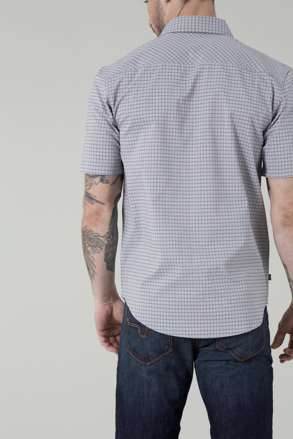 Kimes Ranch Spyglass Short Sleeve Dress Shirt in Grey, back view, with a fine check pattern and a back yoke