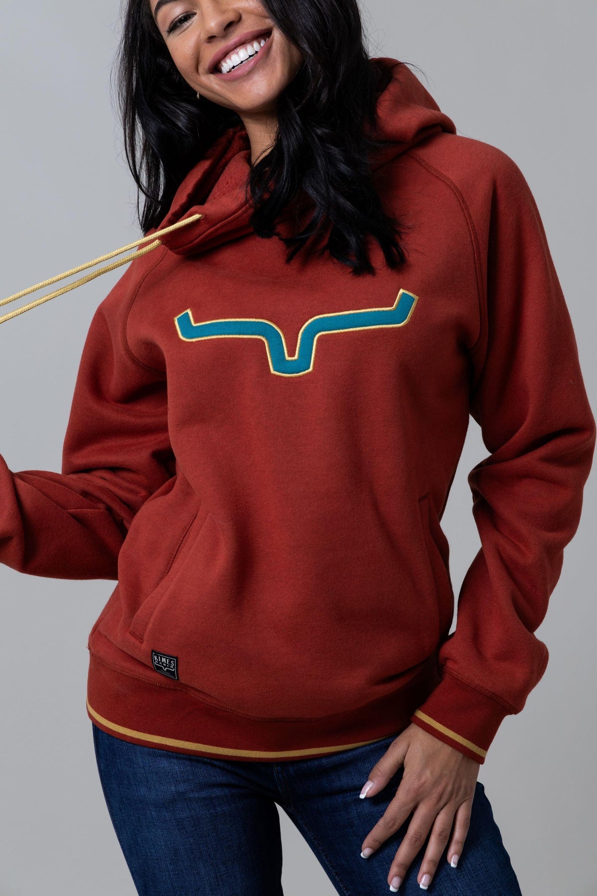 Kimes Ranch Two Scoops Hoodie in Rust with a teal and gold logo and front kangaroo pocket