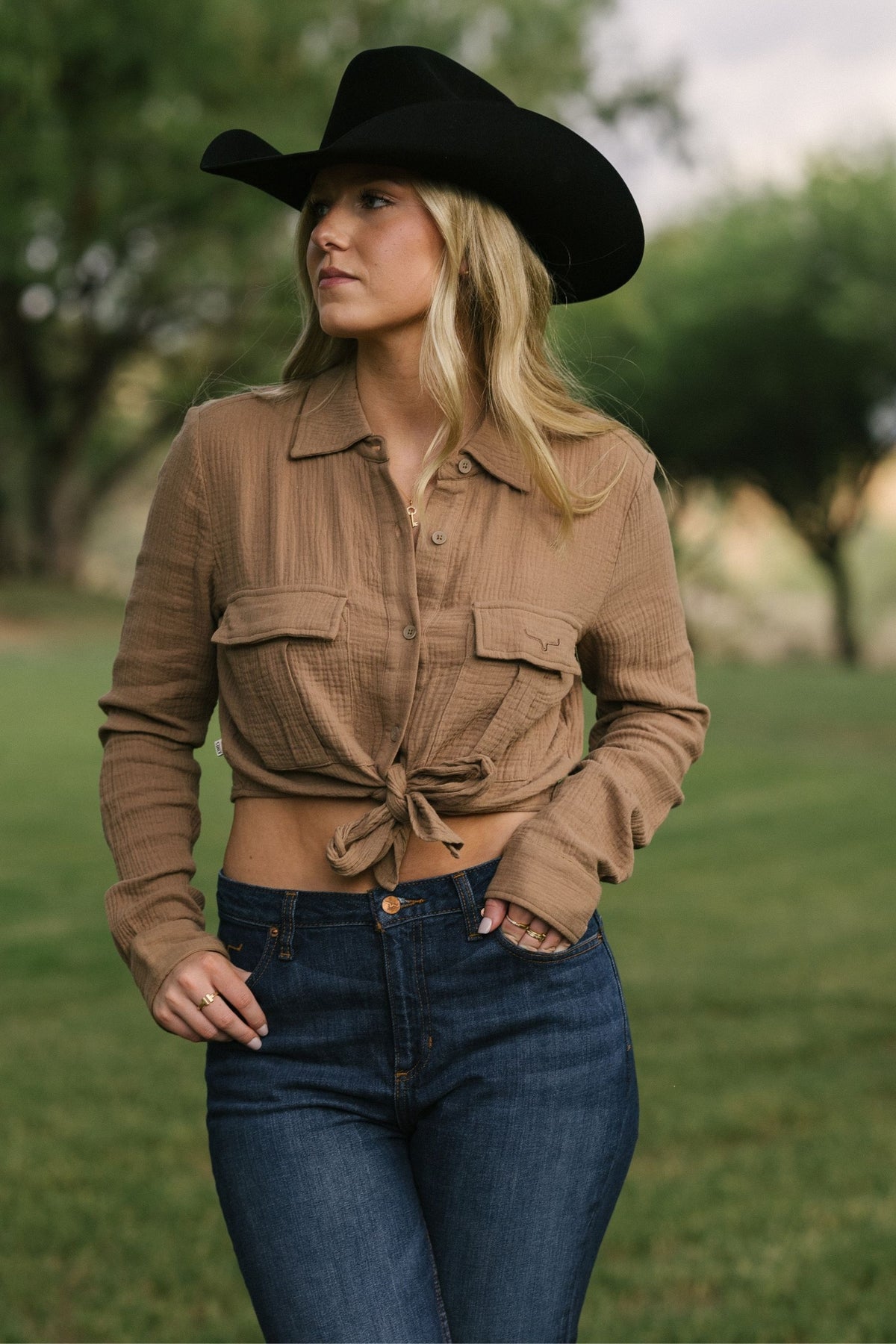 Kimes Ranch Torrean Tie Up top in Taupe with long sleeves, a collar, front pockets, and a front tie detail