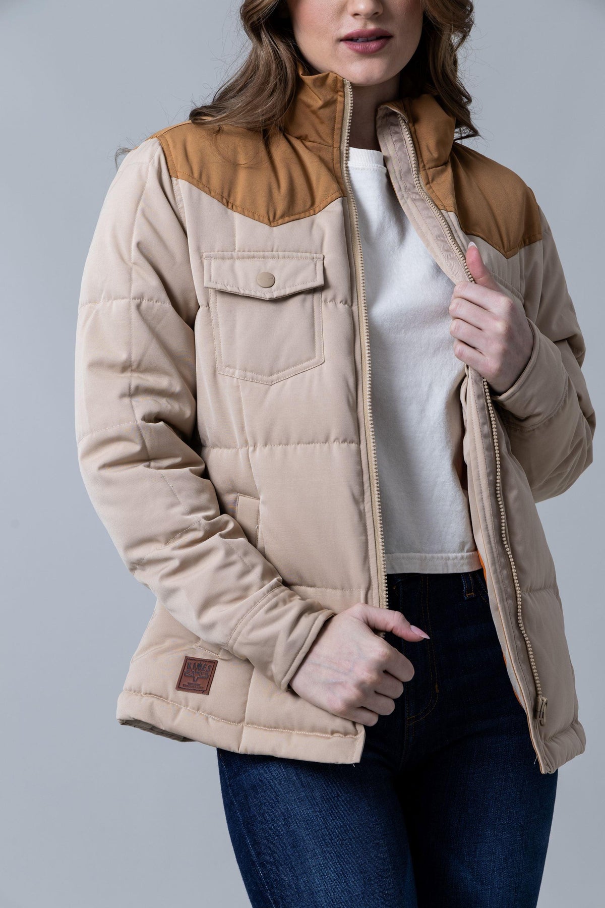 Kimes Ranch Wyldfire Jacket in Tan with a quilted body, contrasting yoke, and front flap pocket