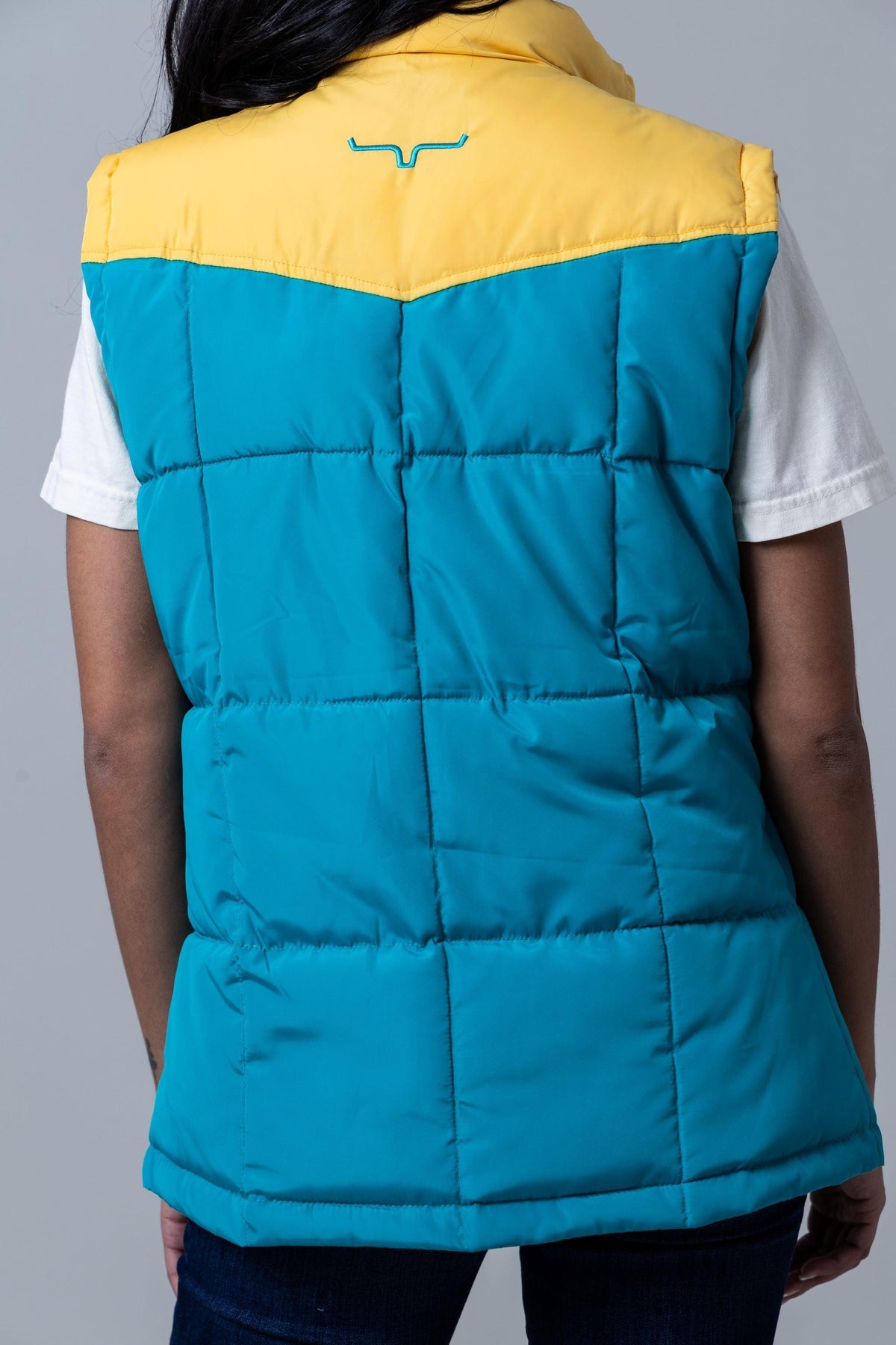 Kimes Ranch Wyldfire Vest, back view, with Teal body and yellow yoke featuring the Kimes Ranch logo