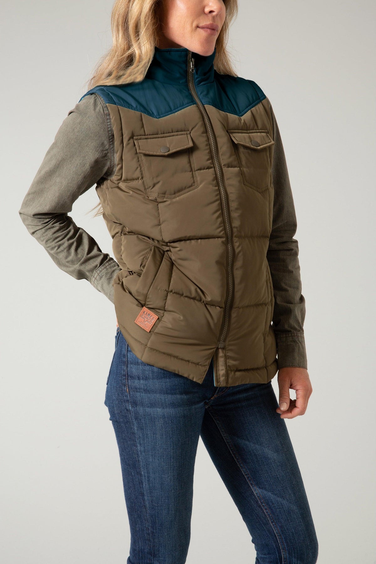 Kimes Ranch Wyldfire Vest in Army, side view, with teal yoke, two chest pockets, and a front zipper