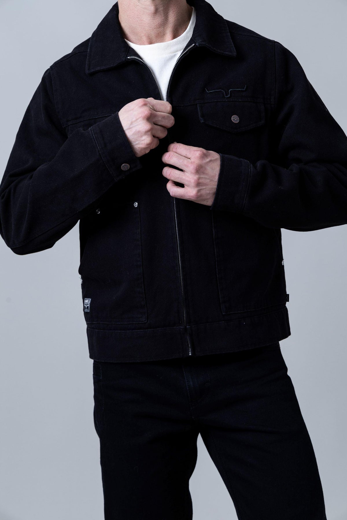 Kimes Ranch Logan Jacket in Black with a zip front, collar, and chest pocket with logo