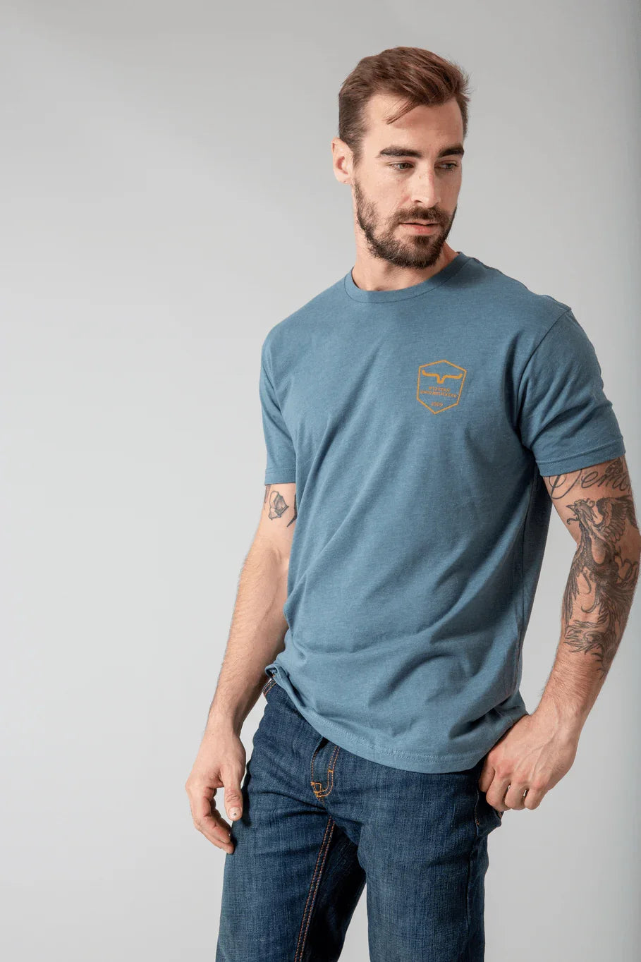 Kimes Ranch Shielded Trucker Shirt in blue with a shield logo on the chest