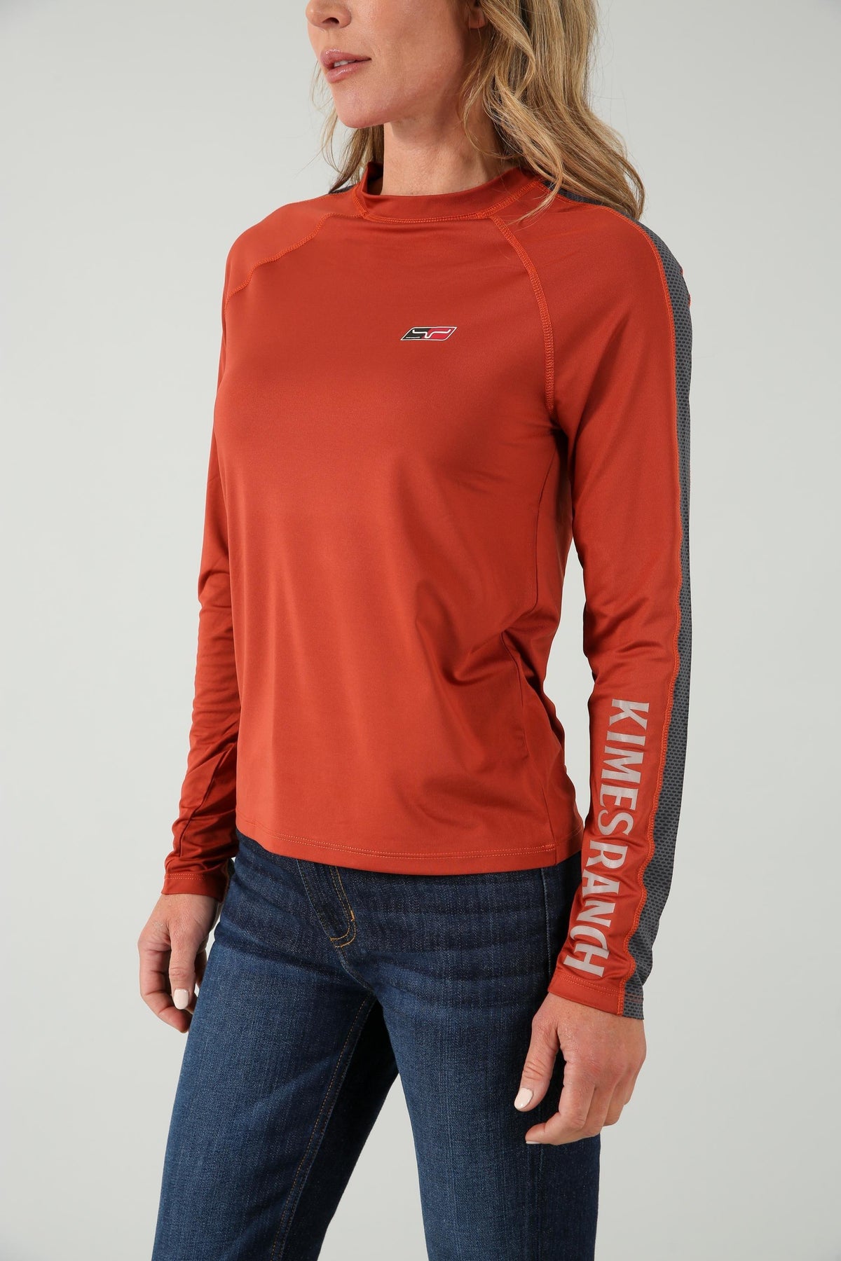 Kimes Ranch K1 Ls Tech Tee Shirt in Rust, side view, with a small chest logo and KIMES RANCH text on the sleeve