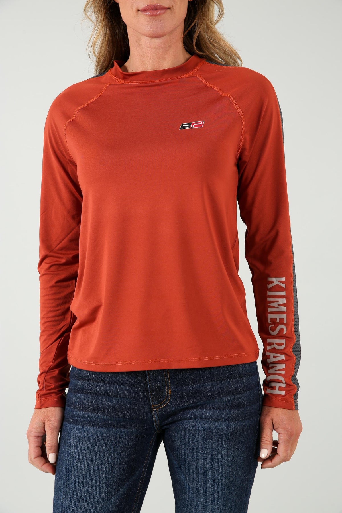 Kimes Ranch K1 Ls Tech Tee Shirt in Rust with a small chest logo and vertical KIMES RANCH text on the sleeve