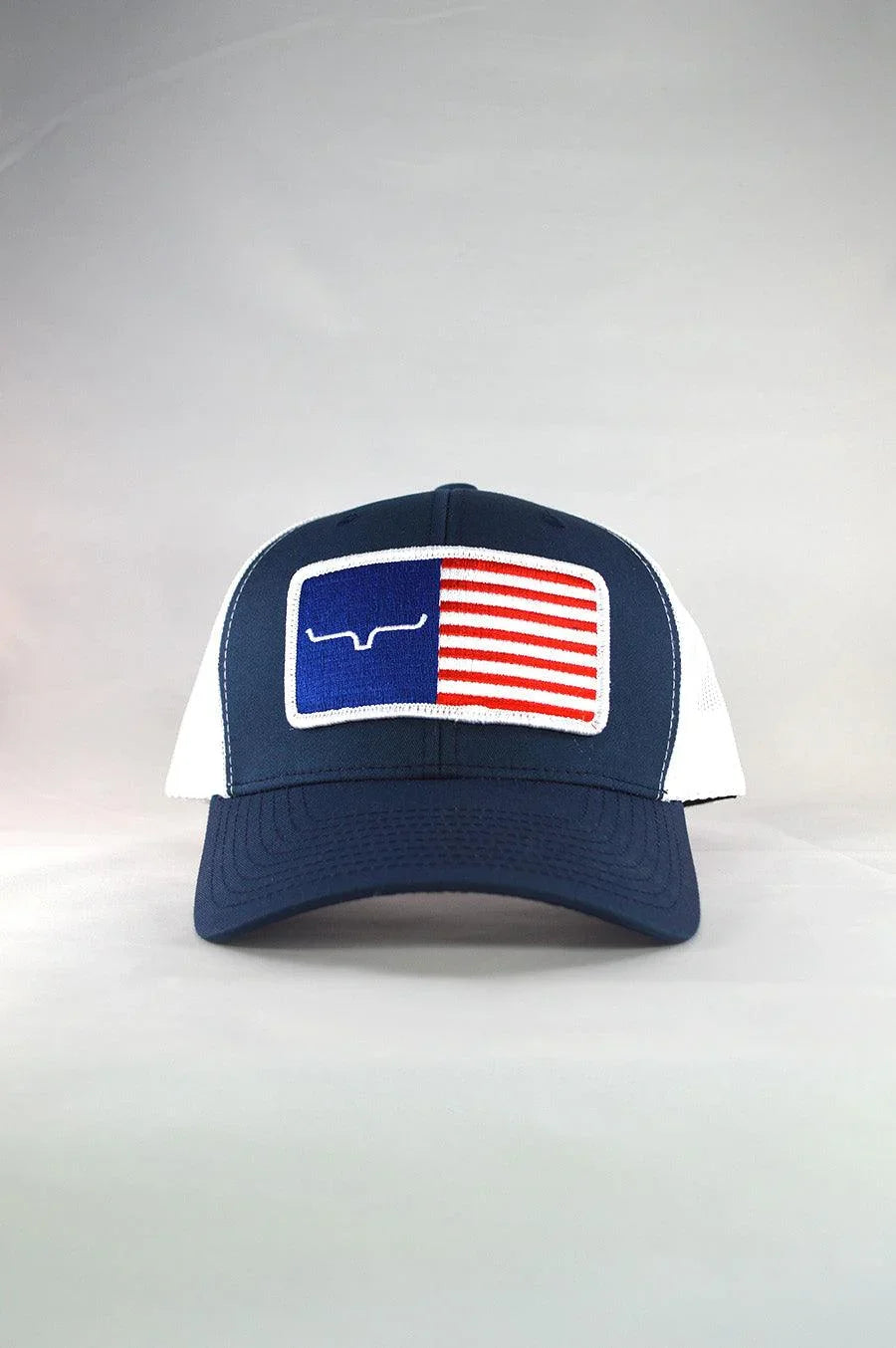 Kimes Ranch American Trucker Hat in navy and white with a Texas flag patch featuring the Kimes Ranch logo