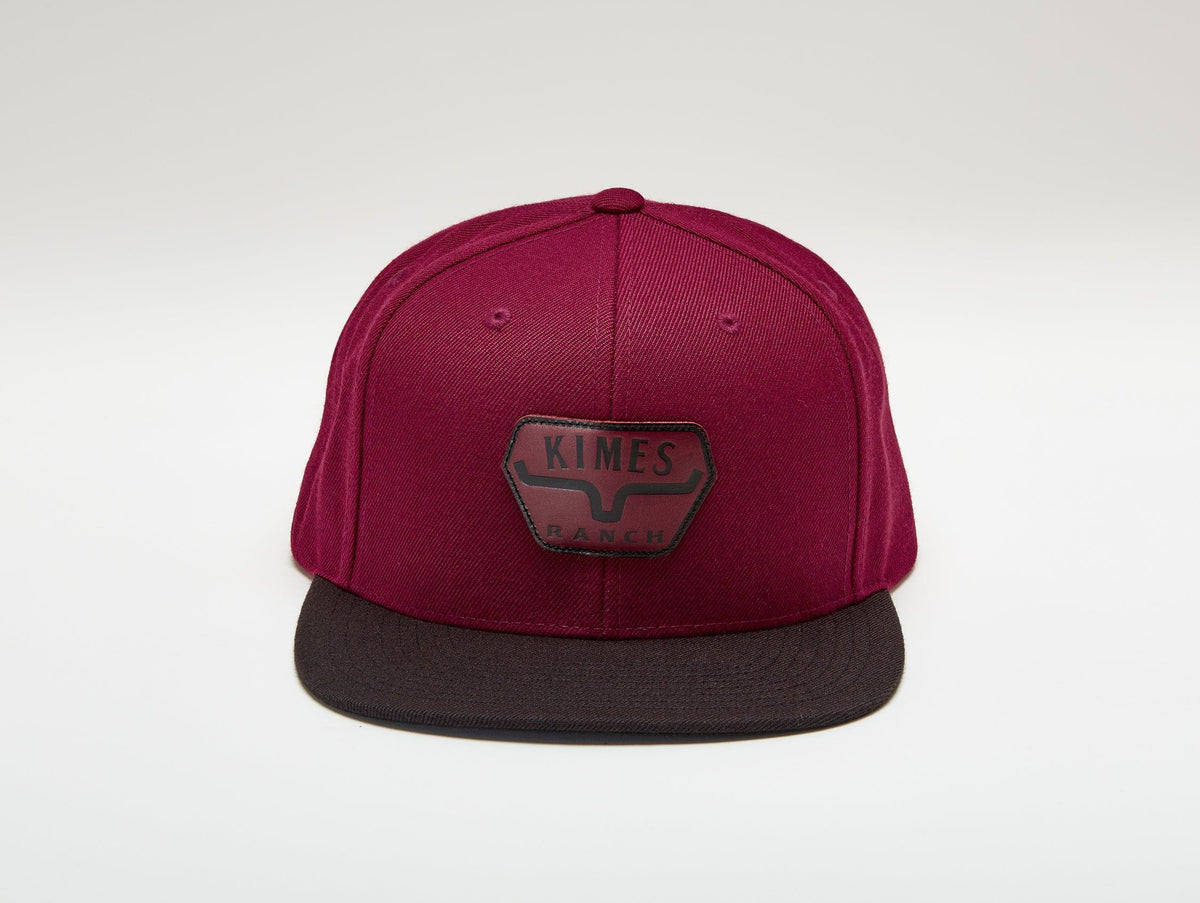 Kimes Ranch Premium Distance Hat in Rust with a flat brim and the Kimes Ranch logo on the front