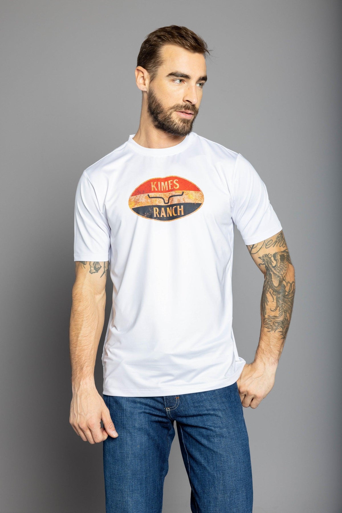 Kimes Ranch American Standard Tech T-Shirt in Stone White with a vintage oval graphic featuring the Kimes Ranch logo