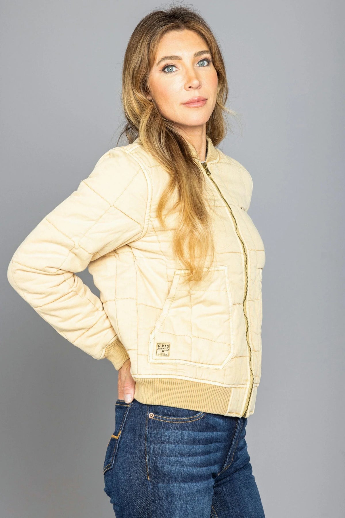 Kimes Ranch Bronc Bomber Jacket in Off White, side view, with quilted diamond stitching and front patch pocket