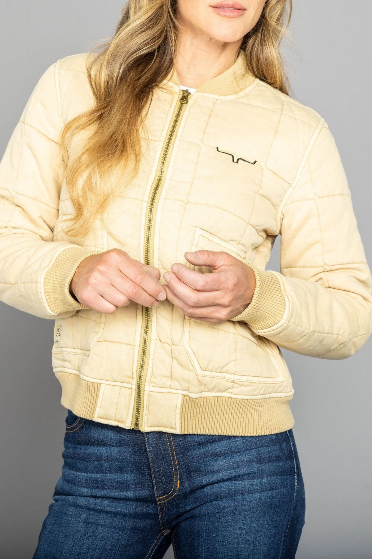 Kimes Ranch Bronc Bomber Jacket in Off White with a front zipper and chest logo