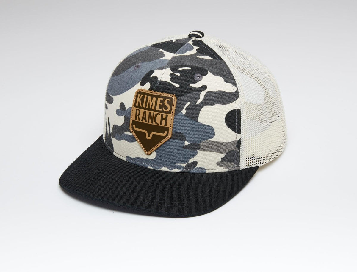 Kimes Ranch Drop In Trucker Hat in Camo, side view, with a black brim and logo patch