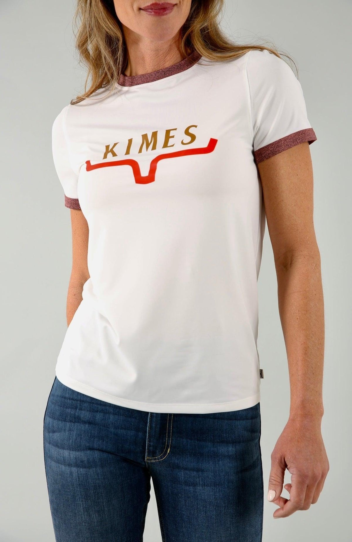 Kimes Ranch Fast Kimes Tech Tee in Natural with a gold KIMES wordmark and red steer logo on the chest