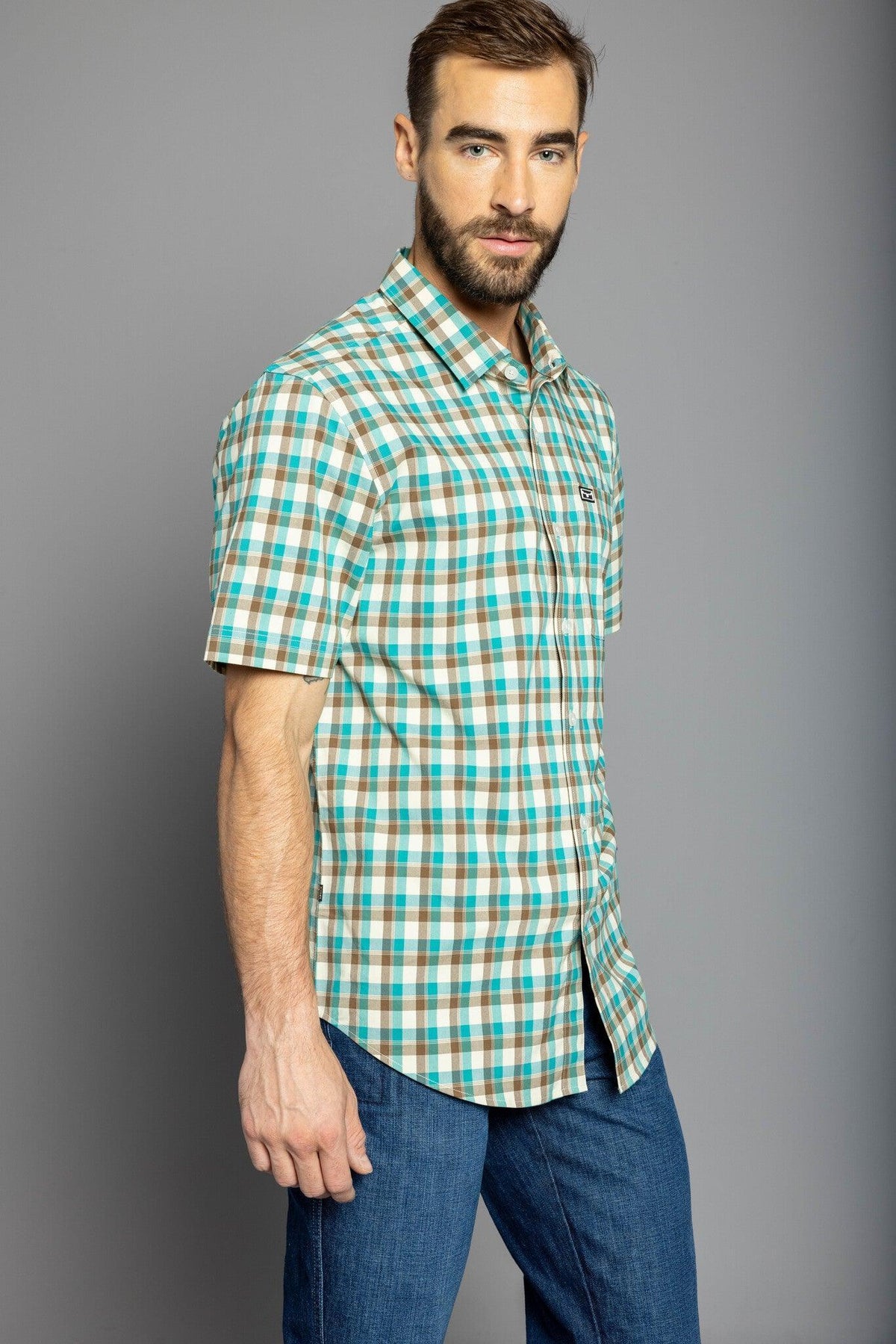 Kimes Ranch Go Round Plaid Dress Shirt in Teal, side view, with short sleeves and a chest pocket