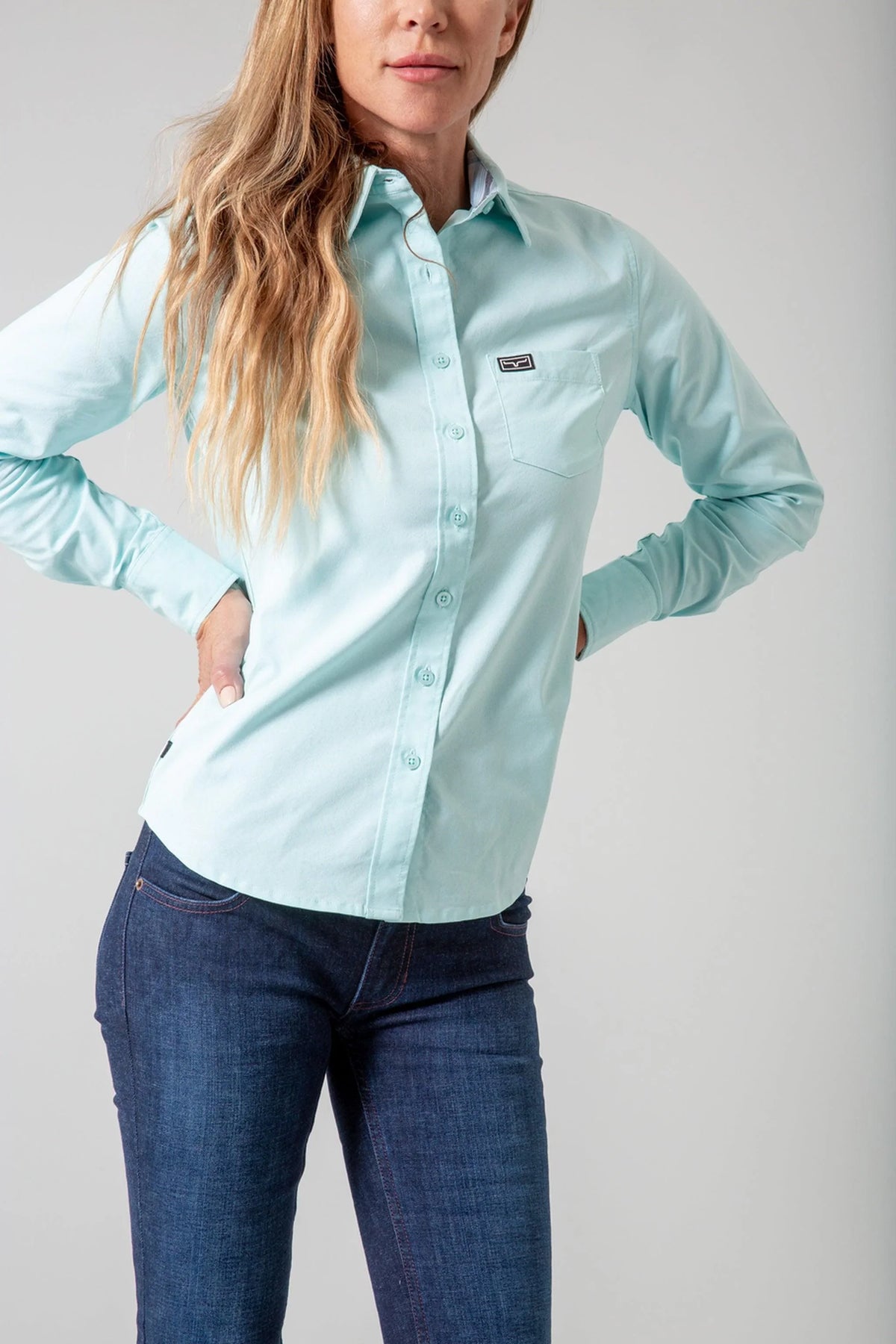 Kimes Ranch Ladies Linville long sleeve button-up top in Turquoise with a chest pocket and logo patch