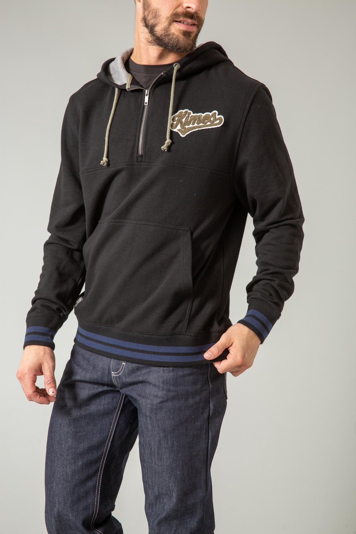 Kimes Ranch Team One Hoodie in Black with a half zip front, kangaroo pocket, and blue striped cuffs